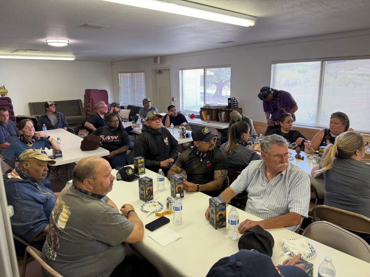 Group of people gathered around long tables