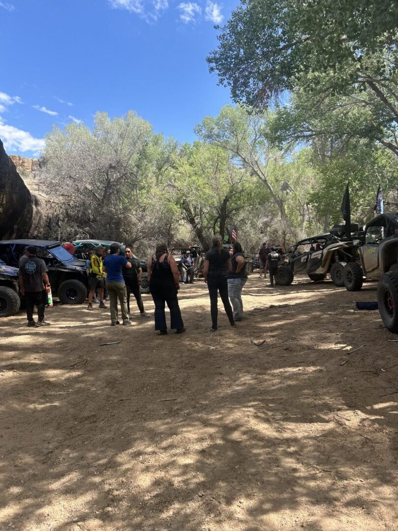 Group of people with off-road vehicles in shade