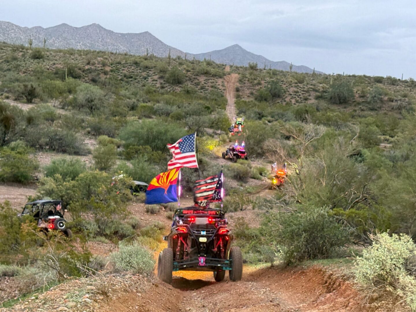Off-road UTVs with American flags in desert