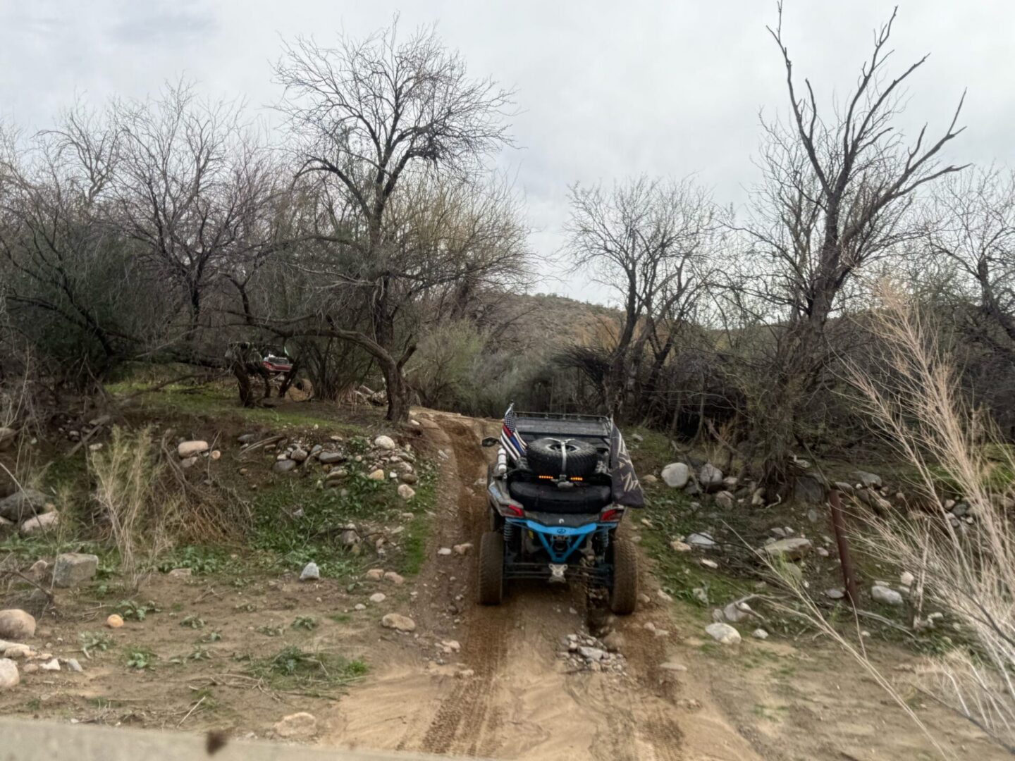 ATV driving on rocky dirt trail