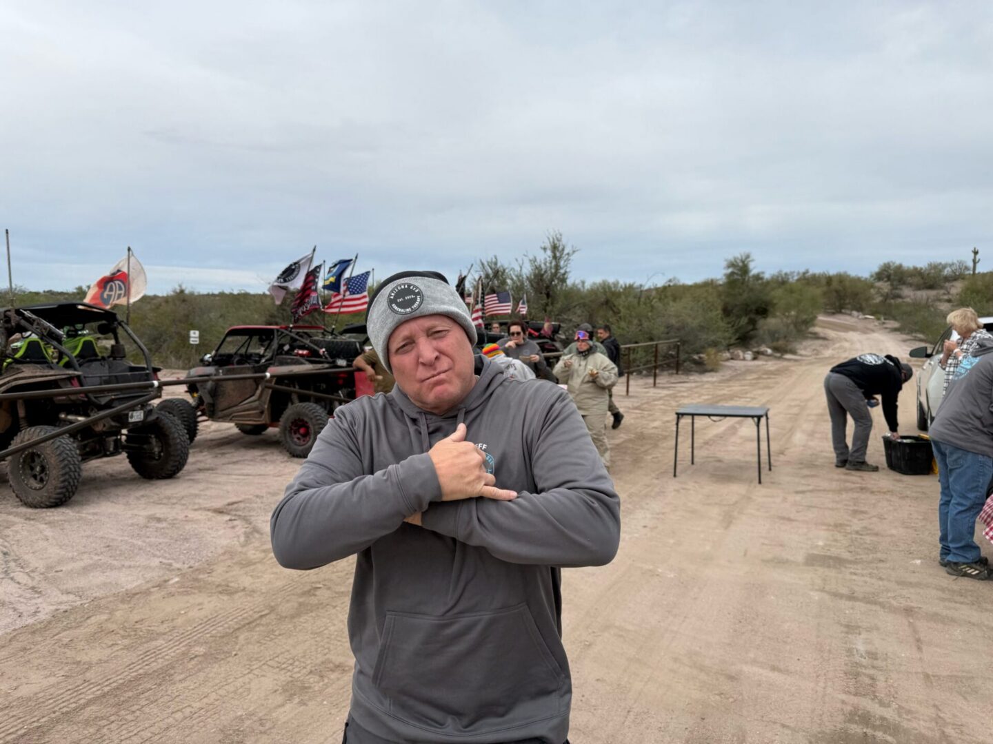 Man posing near off-road vehicles with flags