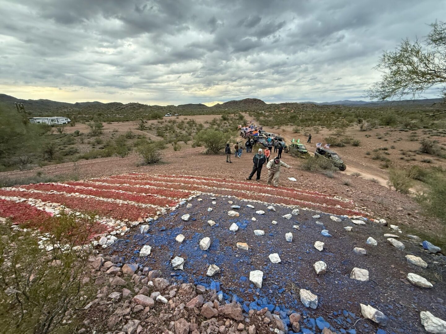 Giant painted American flag on desert hillside