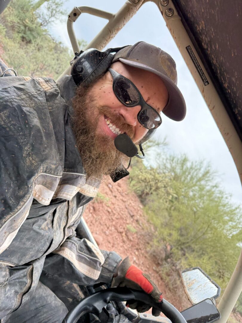 Smiling bearded man driving off-road vehicle