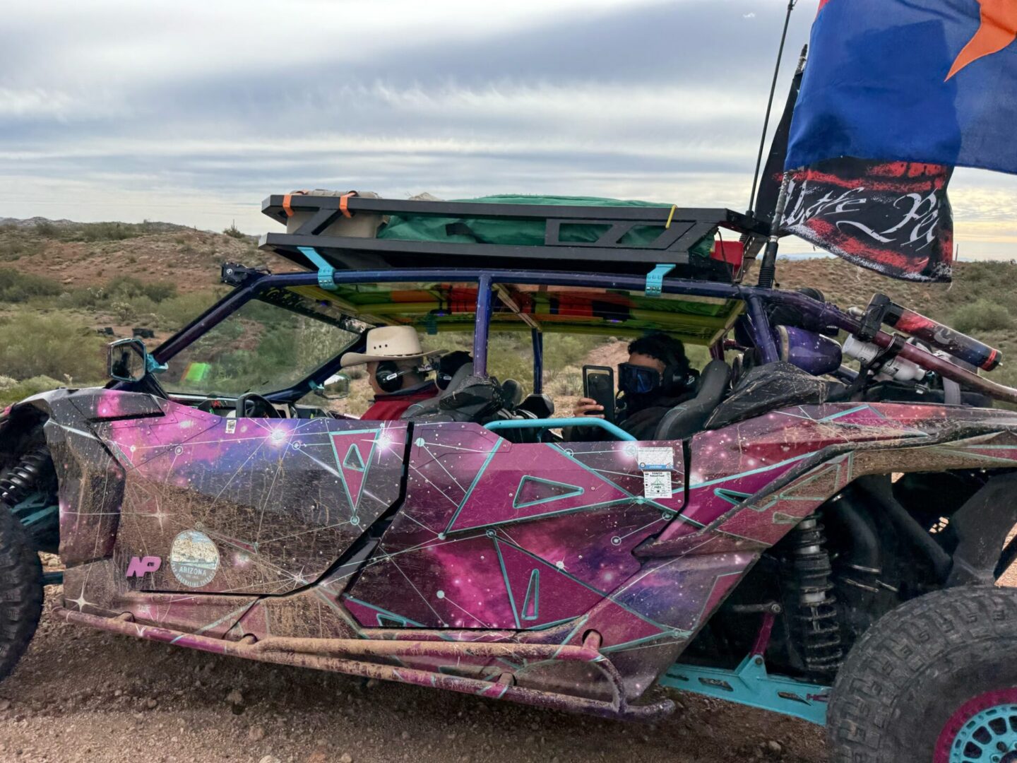 Pink galaxy-wrapped off-road buggy with riders