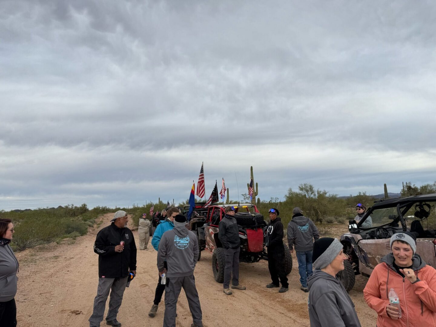 Group of off-roaders with flags in desert