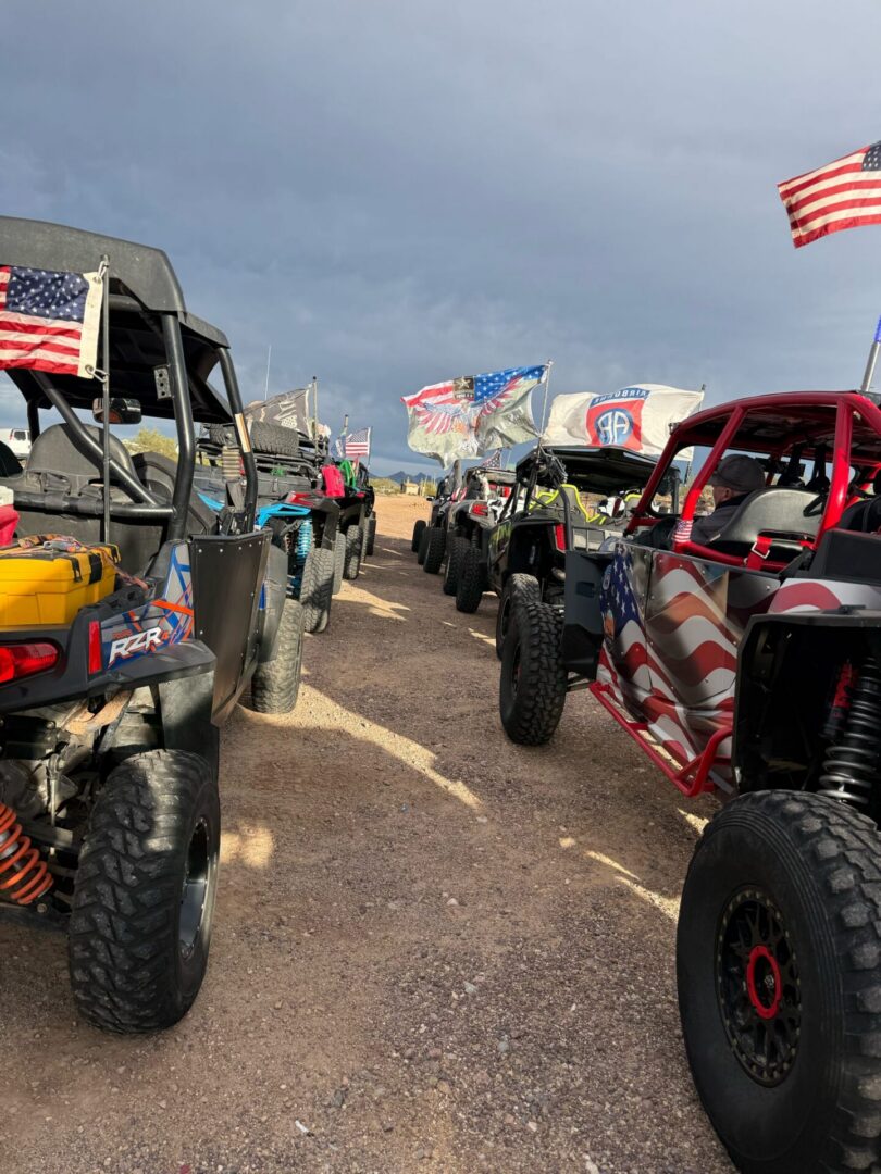 Off-road UTVs lined up with American flags