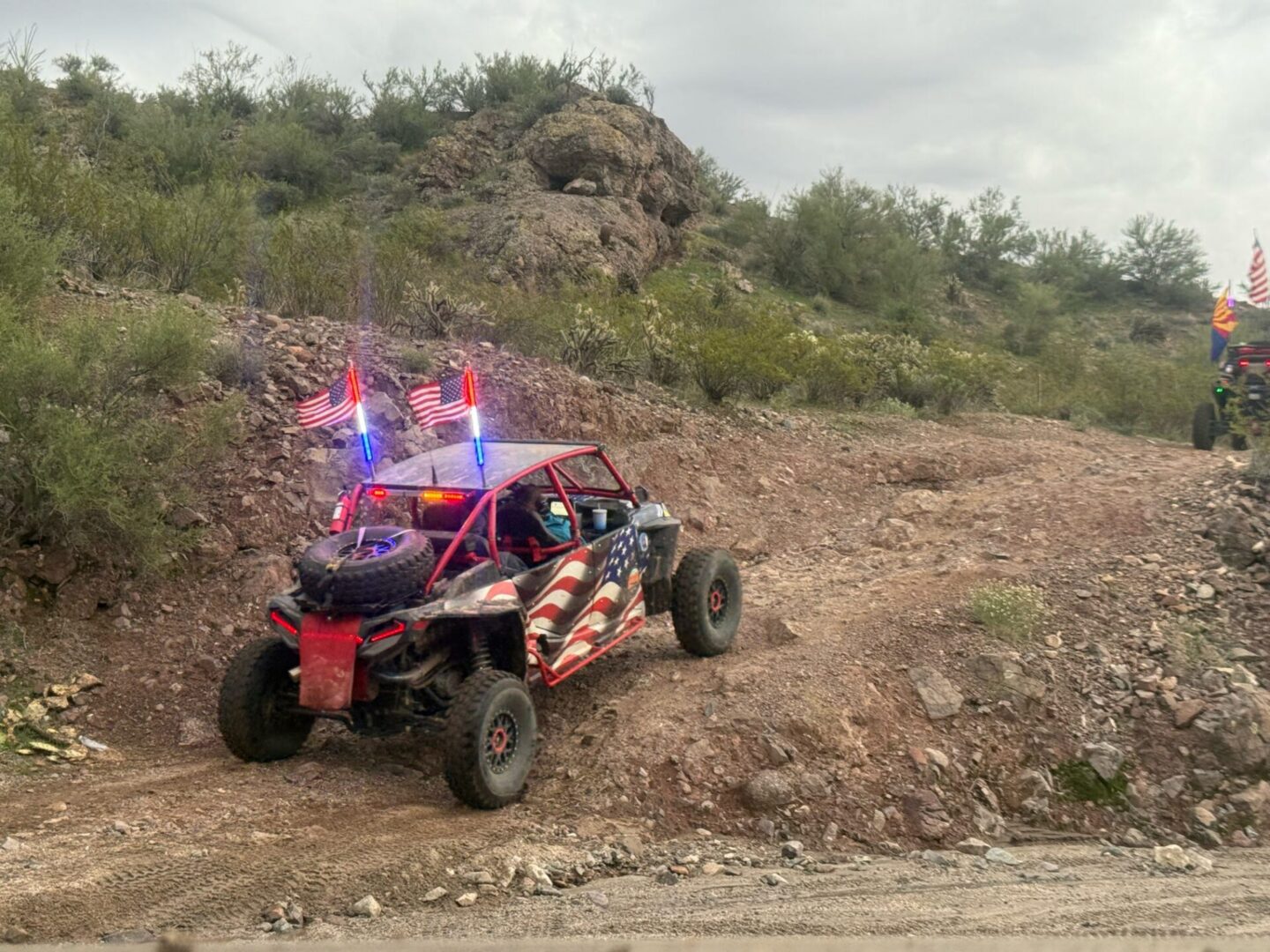 Patriotic off-road dune buggy on rocky trail