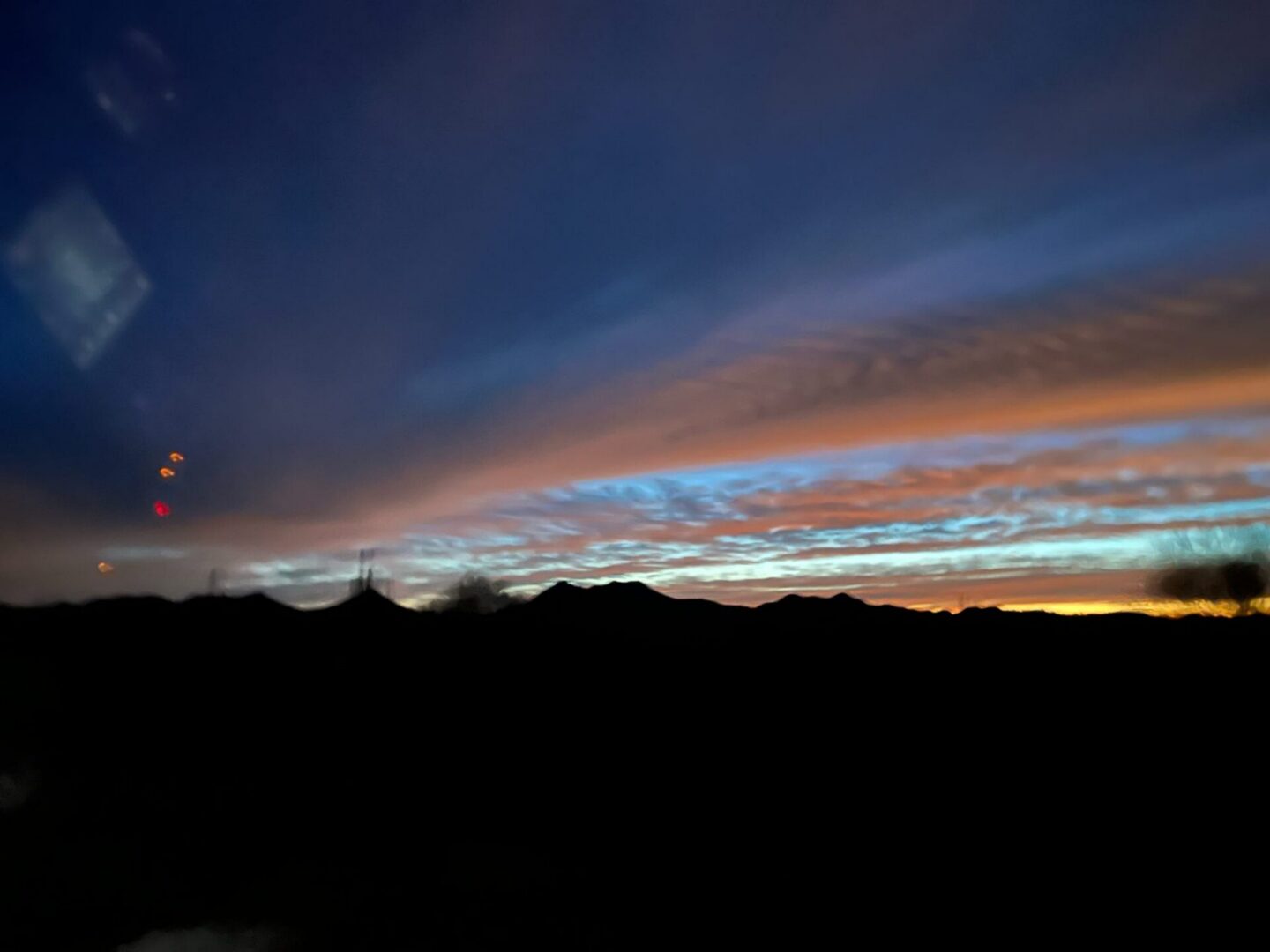 Colorful sunset sky over mountain silhouettes