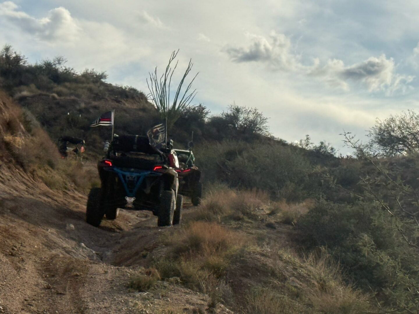 Two off-road UTVs driving on desert trail
