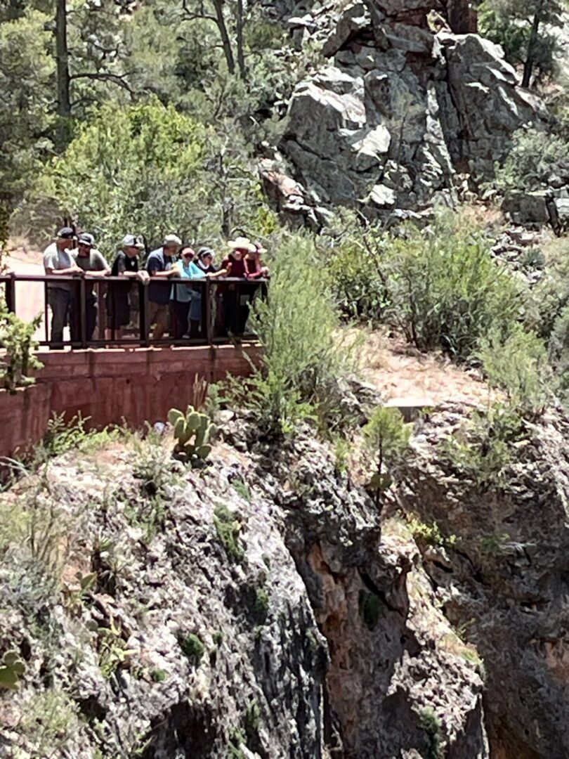 Group of people on overlook above rocky canyon