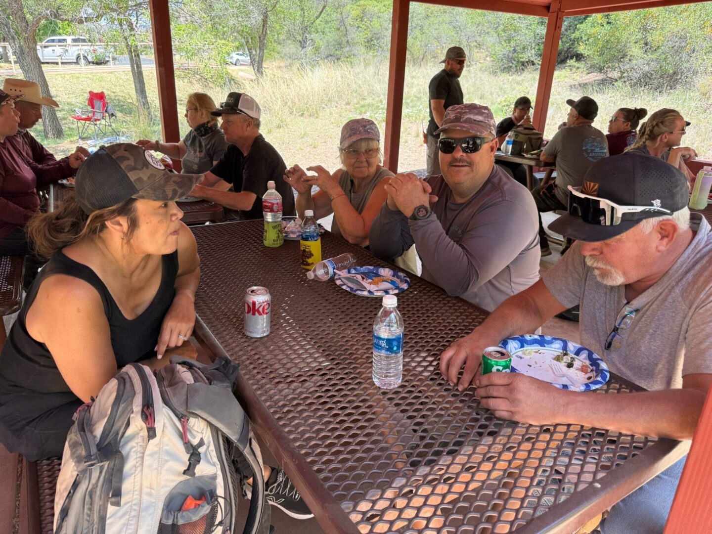 Group of people eating at outdoor picnic table