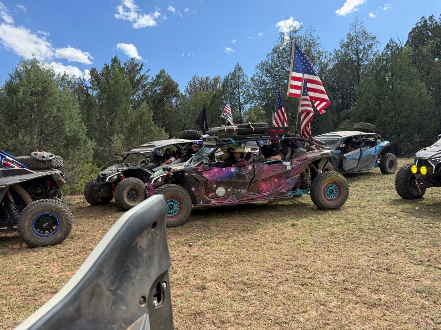 Row of off-road UTVs with American flags